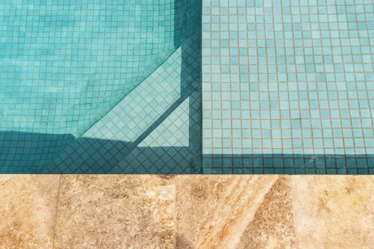 Pool edge showing tile, waterline and stone coping