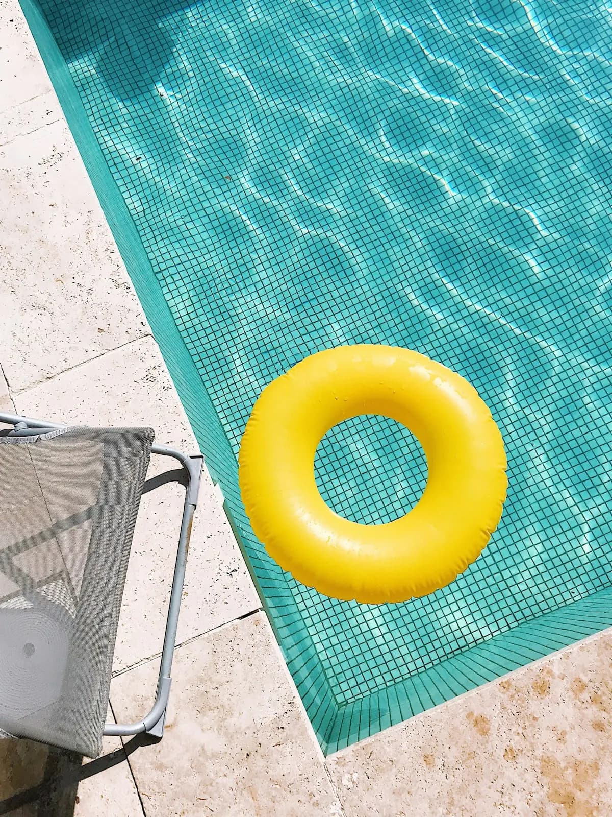 Pool edge with pale coping and turquoise water